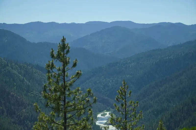 Layered forested ridges and a winding river in Southern Oregon